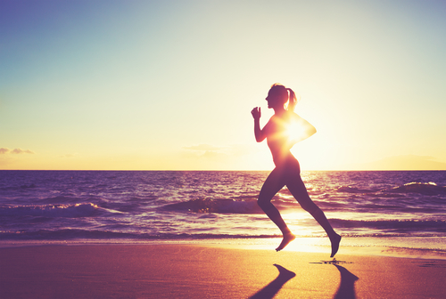 Woman,Running,On,The,Beach,At,Sunset